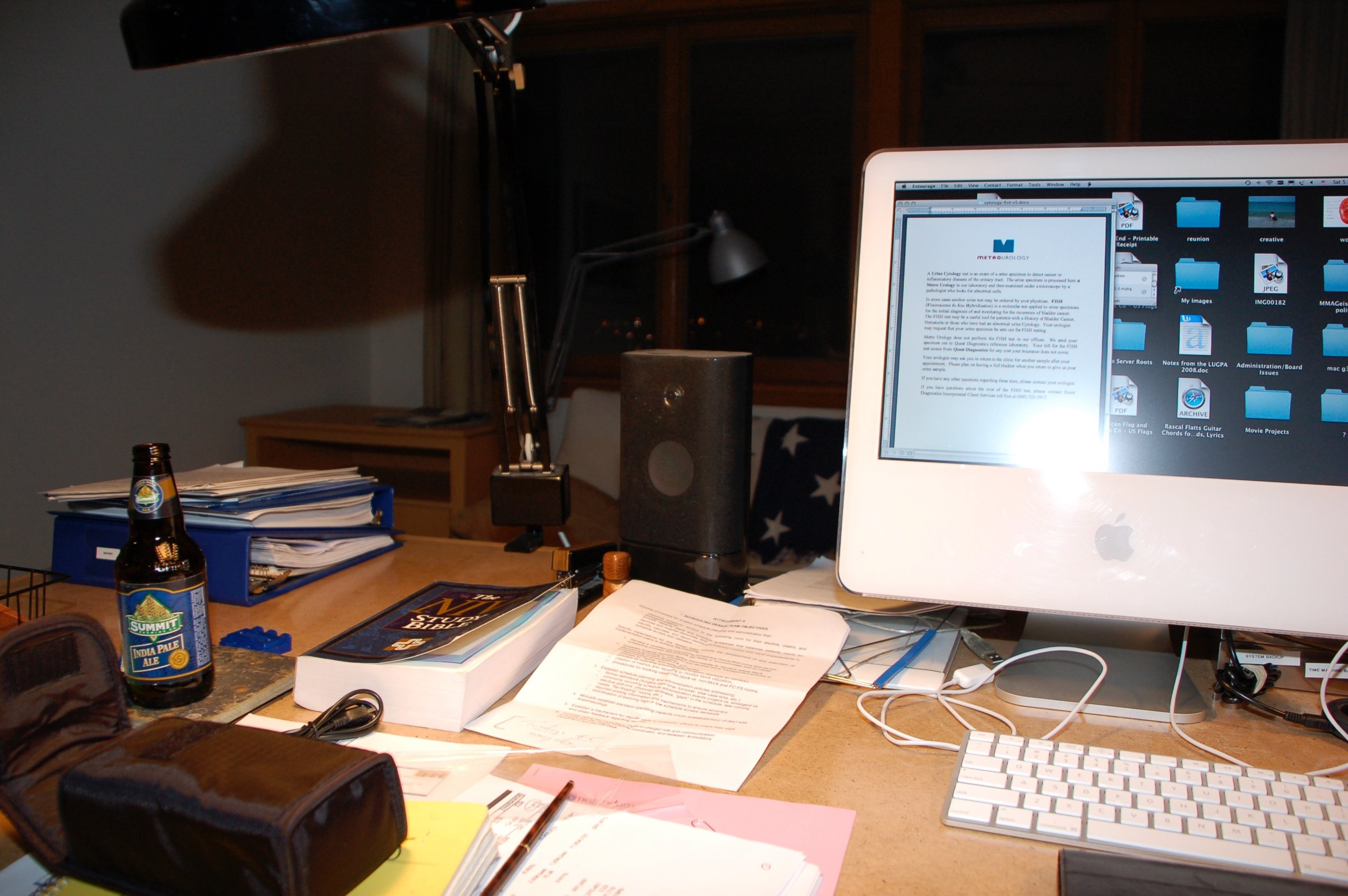  Here is a photo of my old iMac G5 computer. I am typing something for work because you can see the old Metro Urology logo. On the large desk are the essentials for getting work done, including the Bible and beer. 
