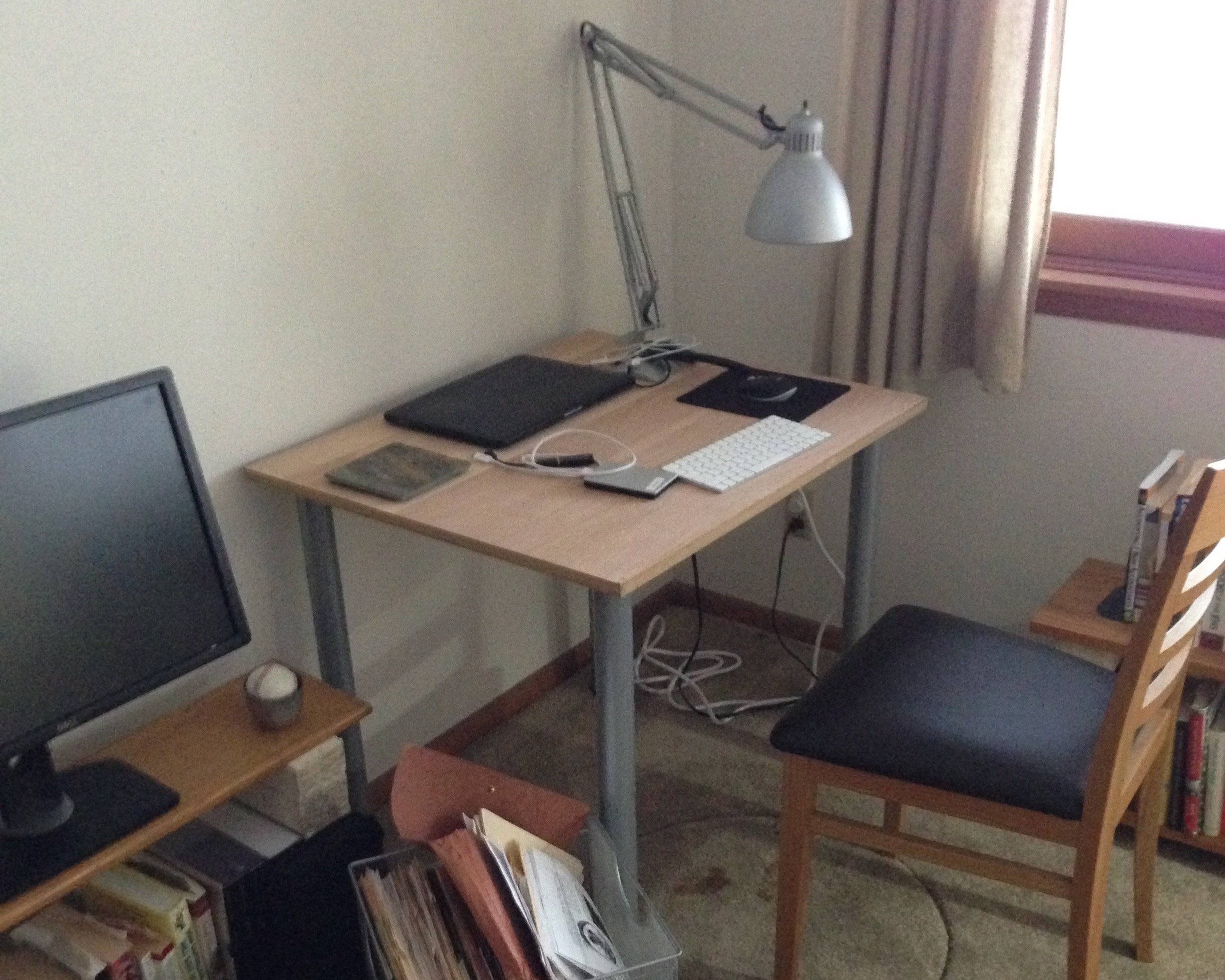 Here is a small desk in the corner of the room, with barely enough space for a laptop and keyboard. Here is where stuff can get done. 